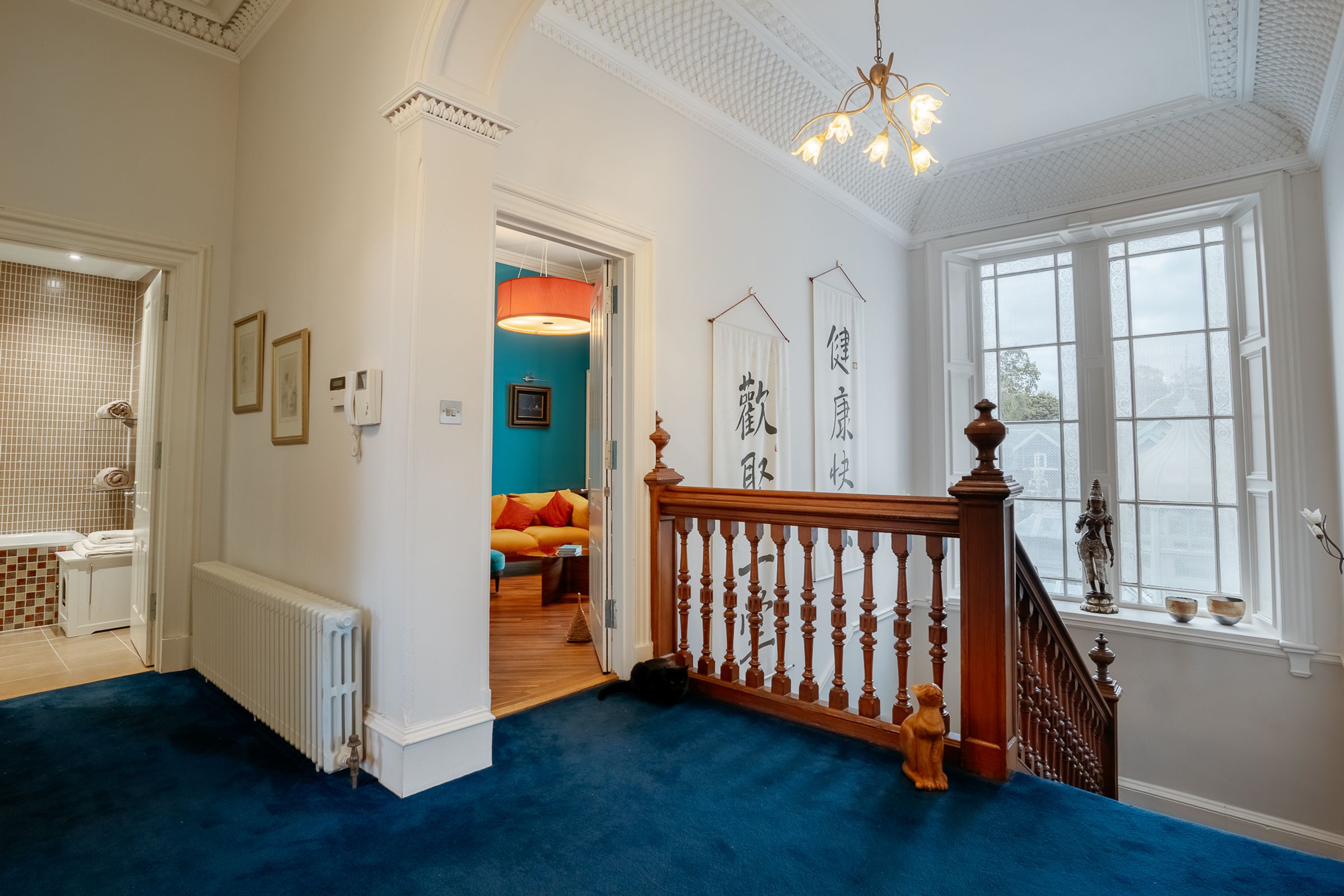 Grand staircase with ornate white woodwork — Edinburgh property