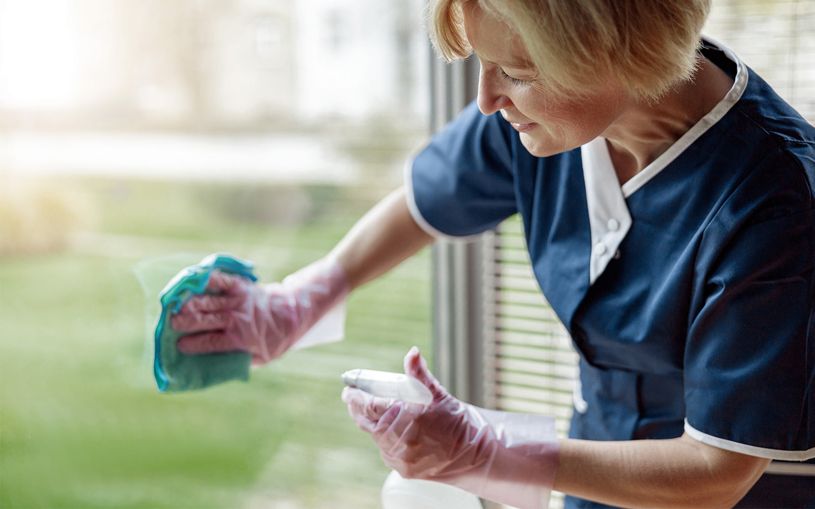Rita Cleaning Services cleaner wiping down a window in an Edinburgh home