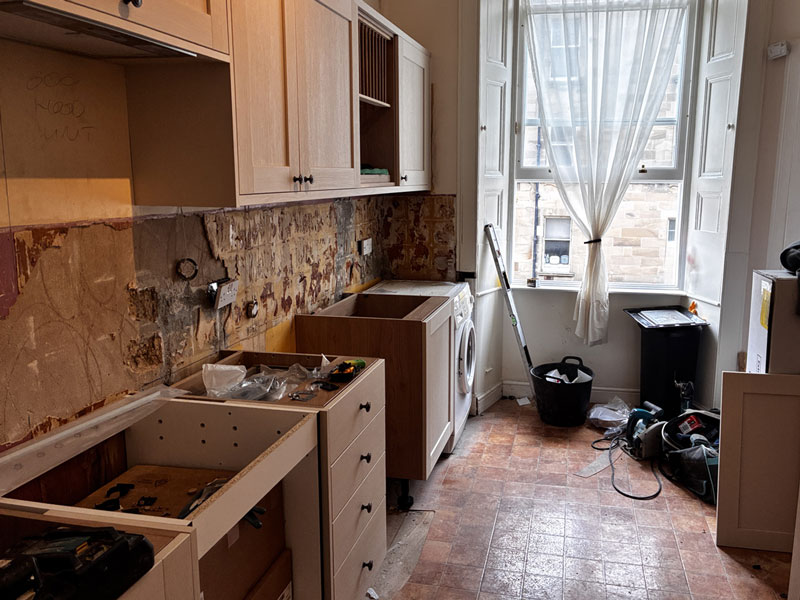 Kitchen stripped back to bare walls and units mid-renovation