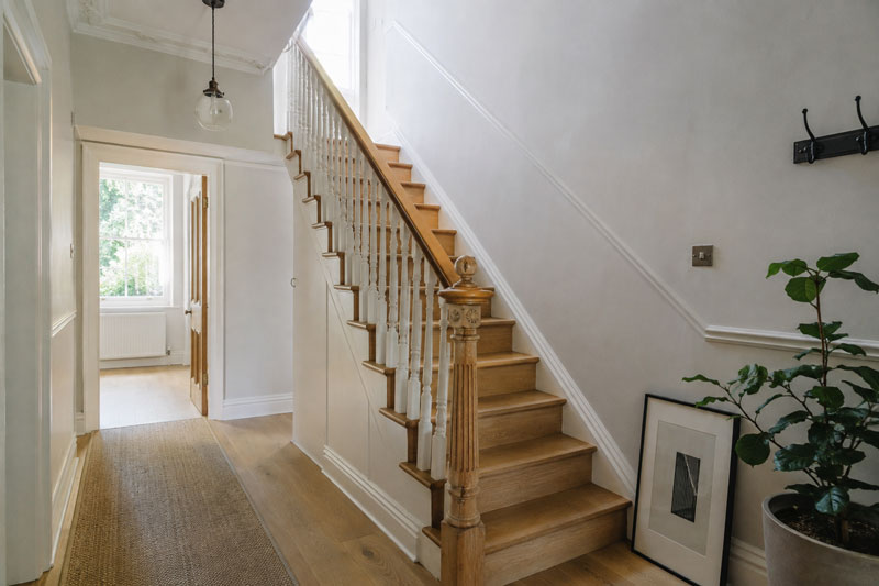 Refurbished period staircase with oak treads, painted spindles and a turned newel post