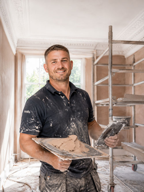 Vincent, founder of V.P.G. Plastering, holding a hawk and trowel in a period Edinburgh property