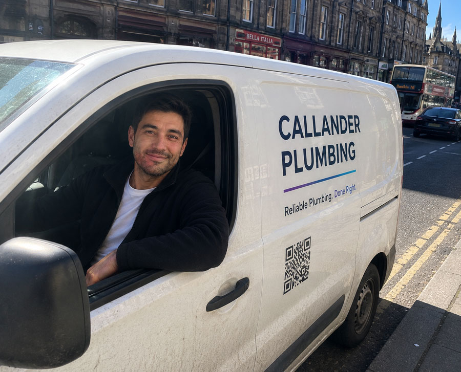 Ross Callander leaning out of the Callander Plumbing van window on an Edinburgh street, van signage and QR code visible