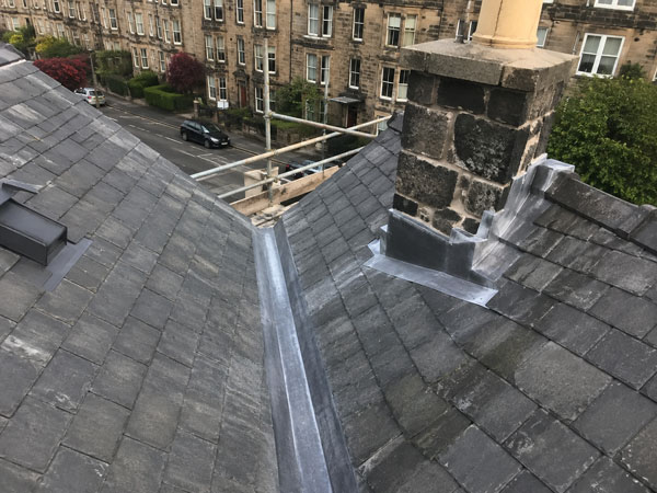 New lead flashing dressed into a roof valley and around a chimney base on an Edinburgh tenement roof